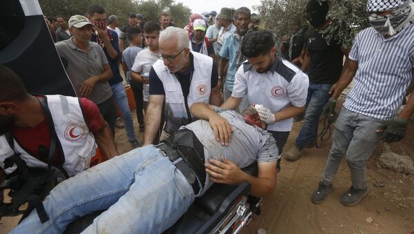 Filistin Kızılayı, İsrail güçlerinin Batı Şeria'nın Beita kasabasında yasa dışı Yahudi yerleşim politikalarına karşı gerçekleştirilen protestoya müdahalesinde 320 Filistinlinin yaralandığını duyurdu. - Sputnik Türkiye