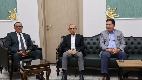 Irak Türkmen Cephesi (ITC) Başkanı Hasan Turan (ortada), Kerkük Valisi Rakan Said el- Cubburi (solda) ile bir araya geldi.
 - Sputnik Türkiye