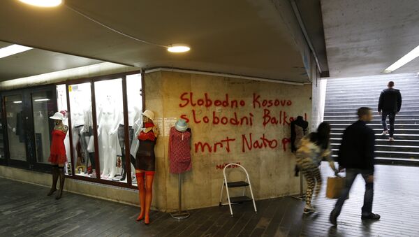 People pass through an underground passage with graffiti on the wall that reads: Free Kosovo, Free Balkan, Death for NATO, in Belgrade, Serbia (File) - Sputnik Türkiye