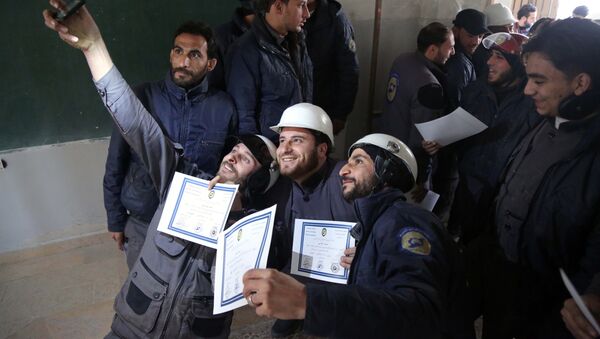 Members of the Syrian Civil Defence, known as the White Helmets, take a selfie with their certificates after taking part in a training session in the rebel-held eastern Ghouta area, east of the capital Damascus, on November 22, 2016 - Sputnik Türkiye