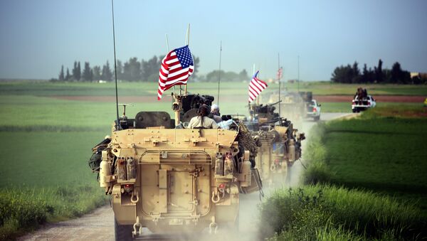 US forces, accompanied by Kurdish People's Protection Units (YPG) fighters, drive their armoured vehicles near the northern Syrian village of Darbasiyah, on the border with Turkey on April 28, 2017 - Sputnik Türkiye