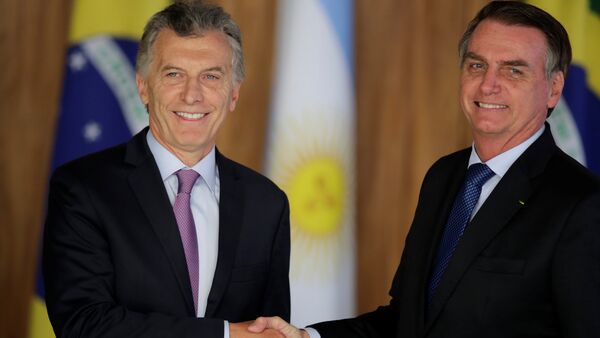 Mauricio Macri  ile Jair Bolsonaro (sağda) Brezilya'daki görüşmede el sıkışırken - Sputnik Türkiye