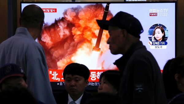 Kuzey Kore'nin Japon Denizi üzerinde balistik füze denemesi olduğu sanılan iki cisim fırlatmasıyla ilgili TV haberlerini takip eden Güney Koreliler  - Sputnik Türkiye